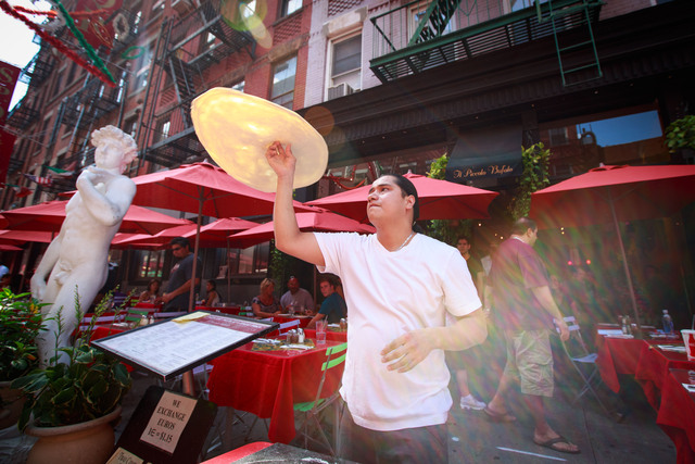 The performance, organized by Little Italy Merchant Associatio, featured a cigar master from the Dominican Republic and a top pizza tosser from Il Piccolo Bufalo restaurant on Mulberry Street on September 1, 2012.