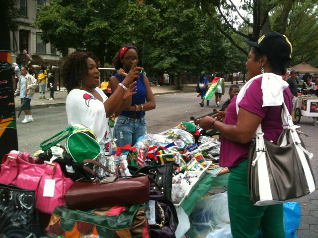 A street vendor sells flags and T-shirts at the 2012 West Indian Day Parade.  
