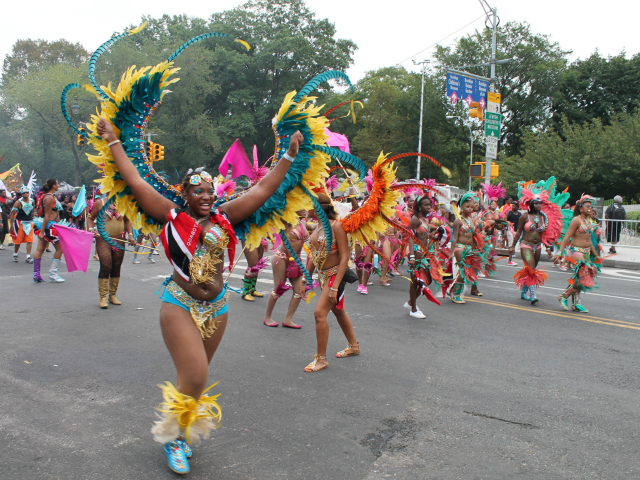 Parade participants wear brightly colored, feathered costumes during the 2012 West Indian-American Day Parade. Sept. 3, 2012. 