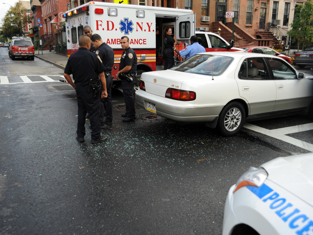 Shattered glass from the crash is seen on the roadway on Tuesday September 4, 2012.