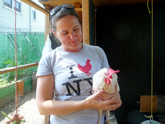 Lily Kesselman, the chicken coop coordinator at Brook Park in Mott Haven, holds Betsy, one of 15 hens that she and a group of volunteers care for.