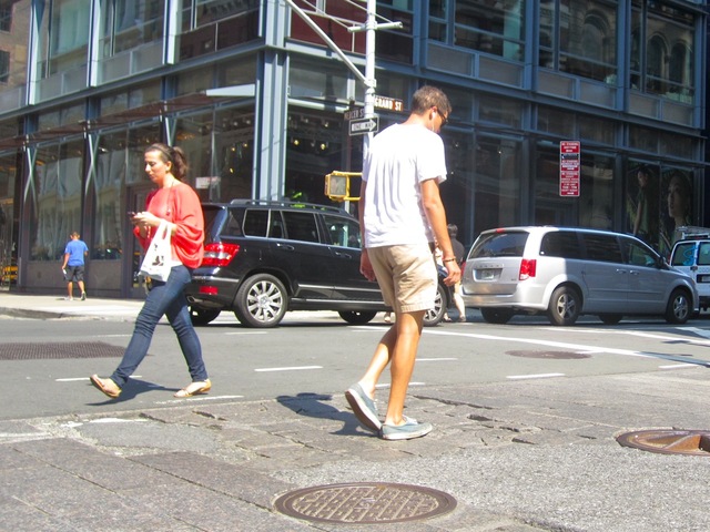Some pedestrians in SoHo avoid the crumbling crosswalks.
