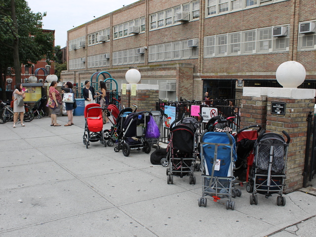 Strollers wait for parents outside P.S. 321 on the first day of school.