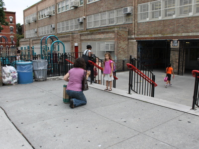 A student poses outside Park Slope's P.S. 321 on the first day of school in September 2012.