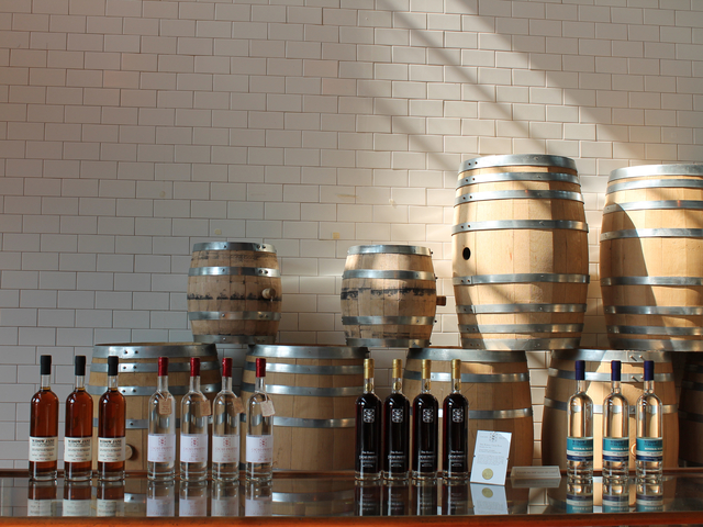 Bottles of whiskey, rum and water stand atop a display case at Cacao Prieto in Red Hook.