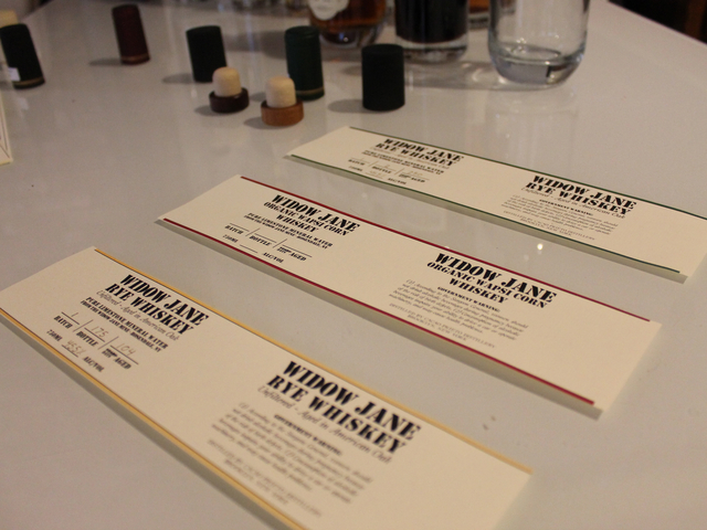 The labels for Cacao Prieto's upcoming spirits sit on a table in the distillery's offices. The Widow Jane Organic Wapsi Corn Whiskey will be aged for at least six months, sales director Alex Clark said.