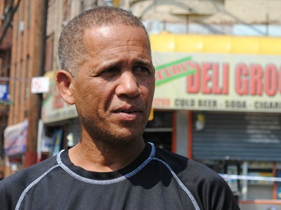 Alcibiades Cuevas stands in front of the bodega where his nephew was shot the night before on Friday September 7, 2012.