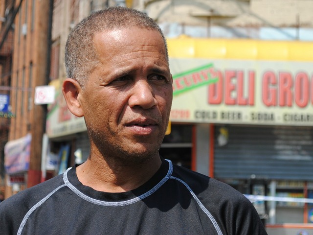 Alcibiades Cuevas stands in front of the bodega where his nephew was shot the night before on Friday September 7, 2012.
