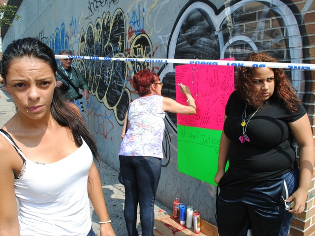 Maria Acevedo, left, was friends with Cuevas and helped create this makeshift memorial for him on Friday September 6, 2012. 