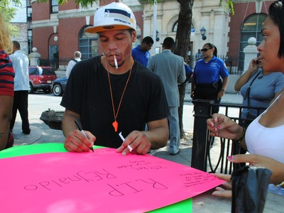 A young man writes a final message to Cuevas who was shot and killed the night before on Friday September 7, 2012. 