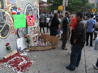 A vigil gathers the day after Reynaldo Cuevas was shot accidentally by a cop while fleeing an armed robbery at his bodega. 