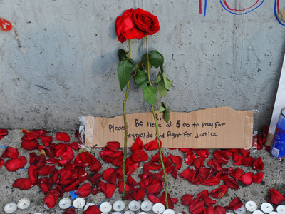 Rose and petals at the site where Reynaldo Cuevas was shot on September 7, 2012, trying to flee an armed robbery.