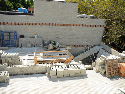 The top section of the building at 214 Carlton Avenue where one worker plunged to his death during a collapse on Monday September 10th, 2012. A large number of cement blocks are stored there.