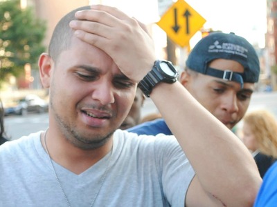 Joel Cuevas, 26, arrives at the scene where his brother Reynaldo, 20, was shot by a police officer while fleeing a bodega robbery on September 7, 2012.