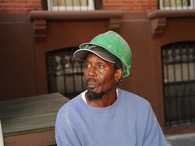 55yr old Ignatius Regis looks with sadness at the building where he survived a roof collapse on Monday September 10th, 2012. One of his colleagues died in the incident.