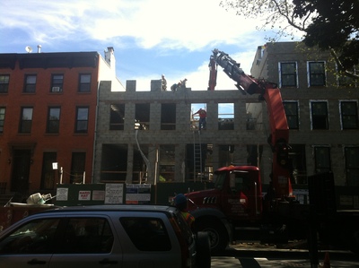 Workers cleared debris at the site of the building collapse on 227 Carlton Avenue.