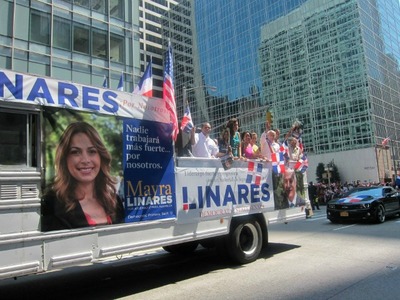Advertisements for Mayra Linares and her father appeared on the same truck at the Dominican Parade.