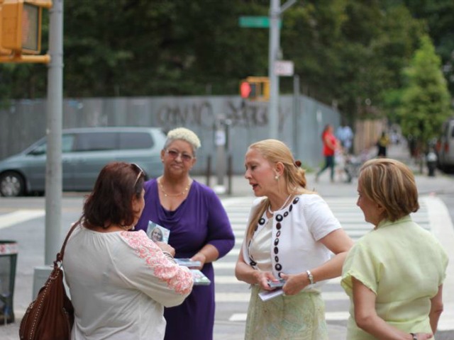 Gabriela Rosa speaks with voters ahead of the Democratic primary.