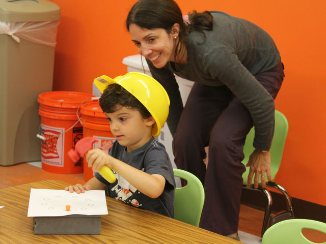 <p>During the Build It! Break It! Fix It! class a child learns to hammer a nail.</p>
