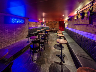 The owners of The Stand used 200-year-old reclaimed wood to help in the soundproofing of the lower level comedy club and to add warmth to the space.
