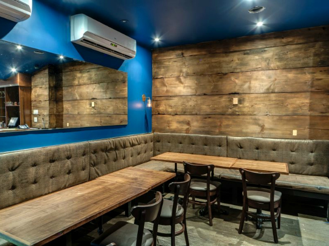 The owners of The Stand used 200-year-old reclaimed wood to help in the soundproofing of the lower level comedy club and to add warmth to the space. 