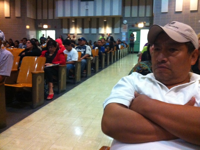 <p>Parents look on at a District 24 meeting designed to address overcrowding.</p>
