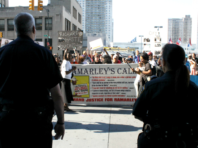 Court police officers watch a rally for Ramarley Graham outside the Bronx County Hall of Justice.
