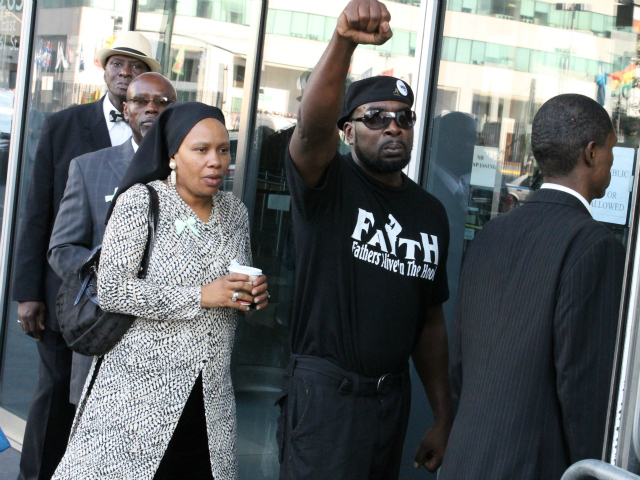 A member of the Graham family's party enters the Bronx County Hall of Justice for Richard Haste's court appearance.