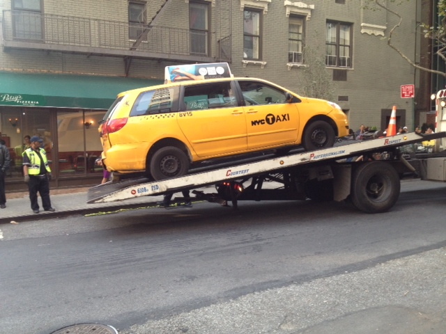A tow truck removes the taxi involved in a fatal accident at East 69th Street and First Avenue on Sept. 17, 2012.