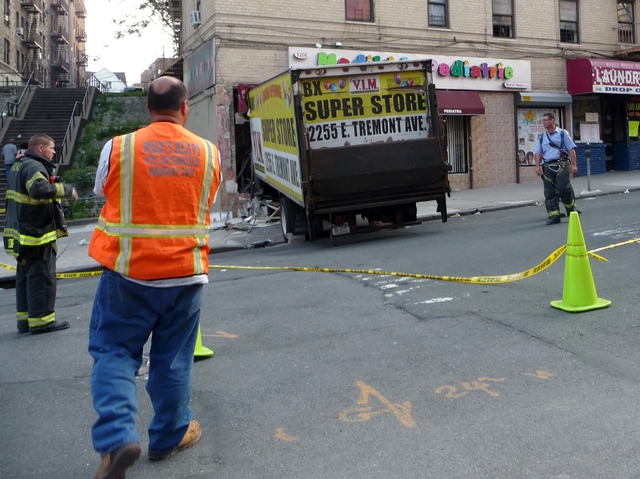 The vehicle was a delivery truck for V.I.M., a clothing store on East Tremont Avenue. Police said the accident was attributed to faulty brakes, and no criminality was involved.