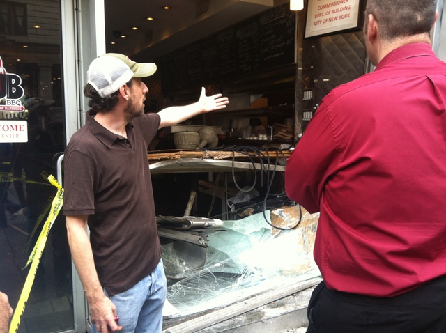 Andrew Fischel, owner of Rub BBQ, looked at the damage after a Hummer crashed into the restaurant Sept. 18, 2012. 