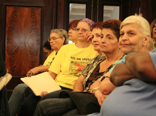 Stakeholders use yellow t-shirts to draw attention to a desire for affordable housing to remain an important part of the SPURA plan. 