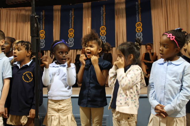 First-graders at Teachers College Community School perform during a welcoming ceremony.