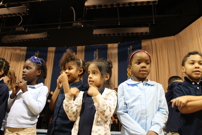 First-graders at Teachers College Community School perform during a welcoming ceremony.