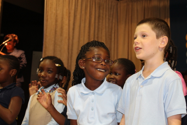 First-graders at Teachers College Community School perform during a welcoming ceremony.