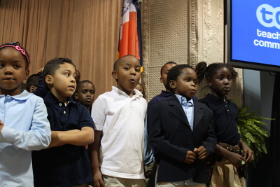 First-graders at Teachers College Community School perform during a welcoming ceremony.