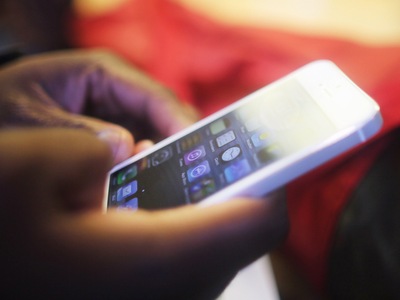 <p>A customer tries out the Apple iPhone 5 inside the Apple Fifth Avenue flagship store.</p>
