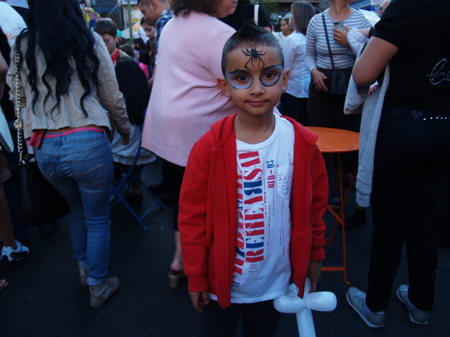 A young festival-goer has his face painted at Viva La Comida!