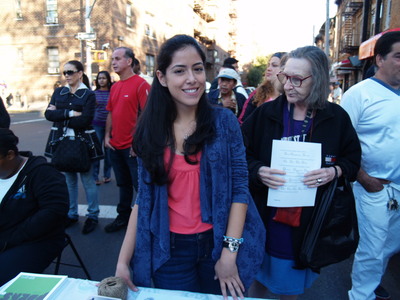 <p>Sofia Davila mans the 82nd Street Partnership booth, handing out information about the organization at the Viva La Comida! festival.</p>
