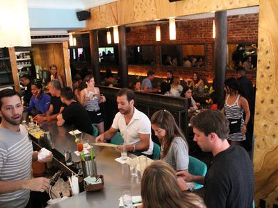 At Extra Virgin on West 4th Street the bar area provides a place for a table of one to brunch.