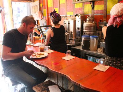 From the bar at Mudspot Cafe you can watch the constant activity of servers as they pull espresso coffee for other patrons at the East Village joint. 