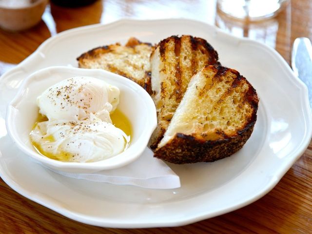 <p>Two Poached Eggs with olive oil, cracked pepper, Maldon sea salt and grilled sourdough at the Standard Grill</p>
