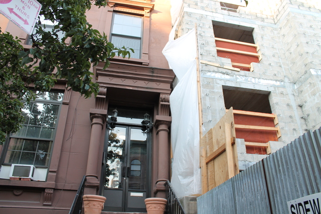 The owner of the brownstone to the left claims in a lawsuit that Abyssinian Development Corporation's construction firm extensively damaged his property.