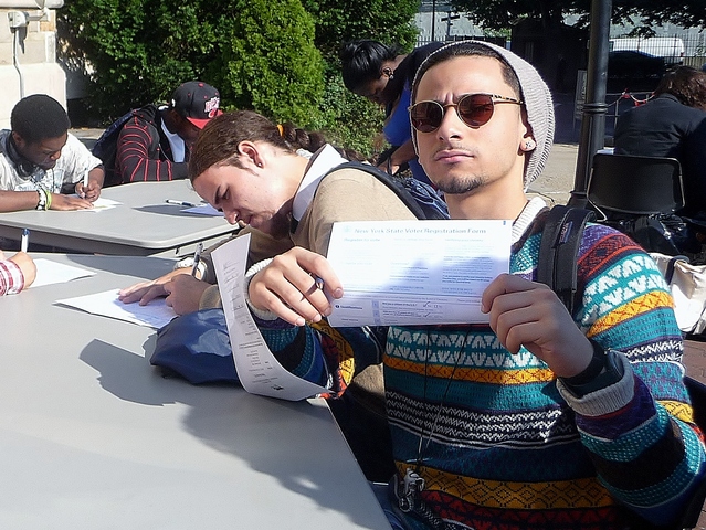 Bronx resident Eli Ramos, 18, fills out a voter registration form for the first time.