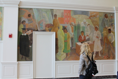 Visitors look at the WPA murals in the new pavilion.