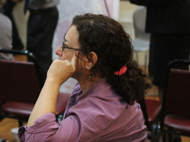 A woman listens in during a Town Hall at the Forest Hills Jewish Center of Sept. 27, 2012.