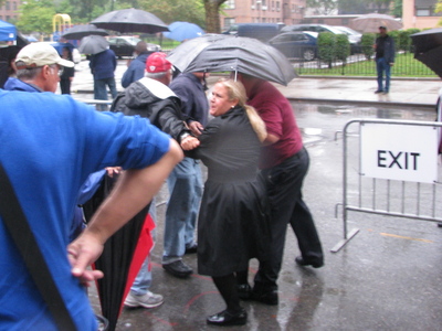 <p>A protester is escorted out of the ceremony after yelling, "you are all pigs."</p>
