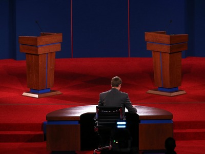 <p>University of Denver student Sam Garry sits at the moderator's desk before a presidential debate dress rehearsal at University of Denver on October 2, 2012 in Denver, Colorado.</p>

