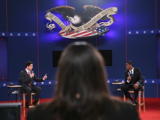 Hofstra University students Josh Ettinger (L) and Tevon Hyman (R) act as stand-ins for Republican presidential candidate Mitt Romney and U.S. President Barack Obama during stage rehearsals for the second presidential debate October 15, 2012 in Hempstead, New York. The debate, a town hall format where the candidates will take questions posed by citizens, will be held Tuesday evening at Hofstra University. 