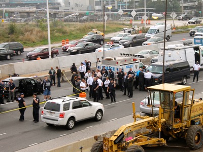 <p>Police investigate in the aftermath of a shooting on the Grand Central Parkway on Oct. 4, 2012.</p>
